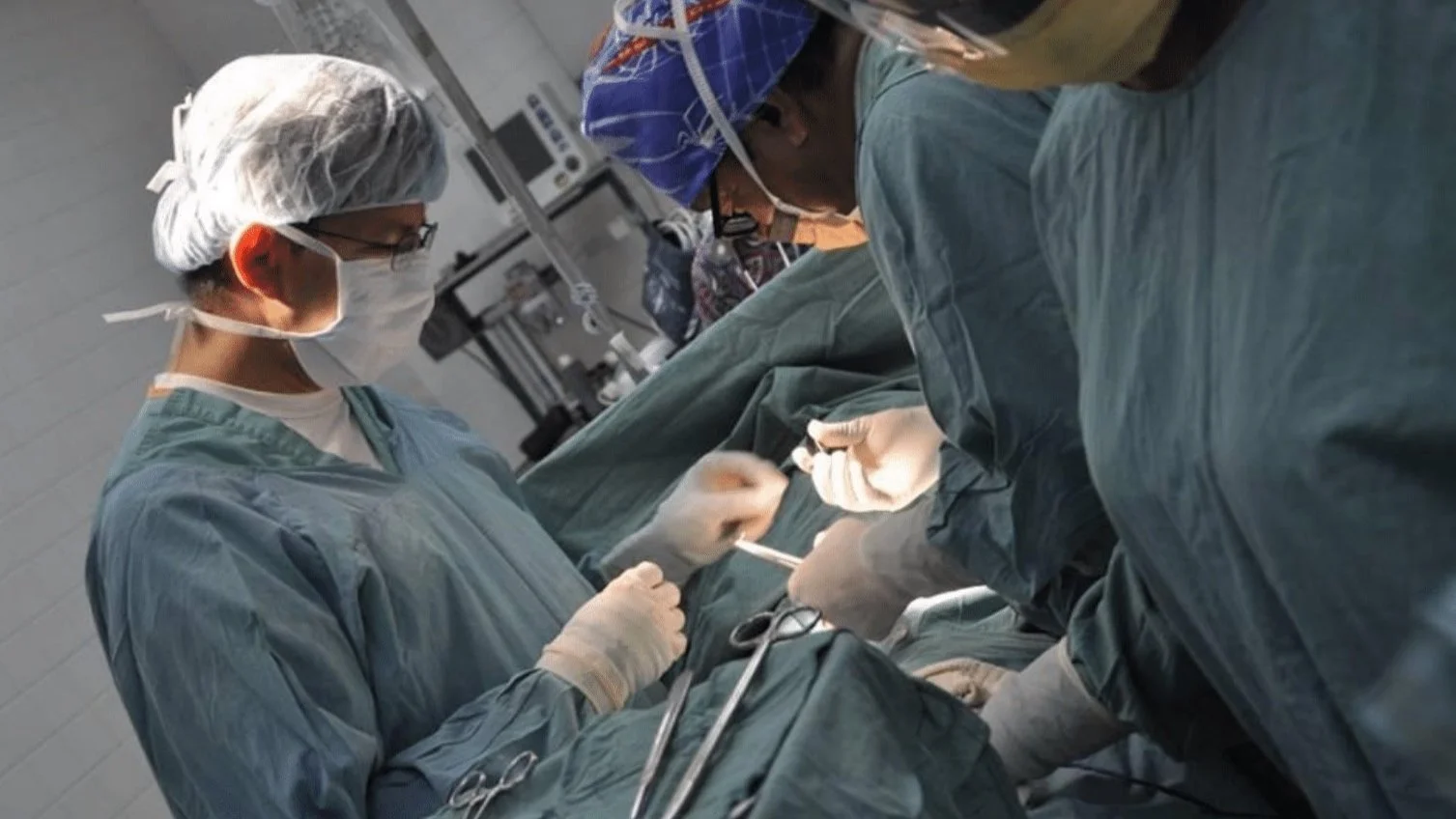 Masked surgical staff in the operating room